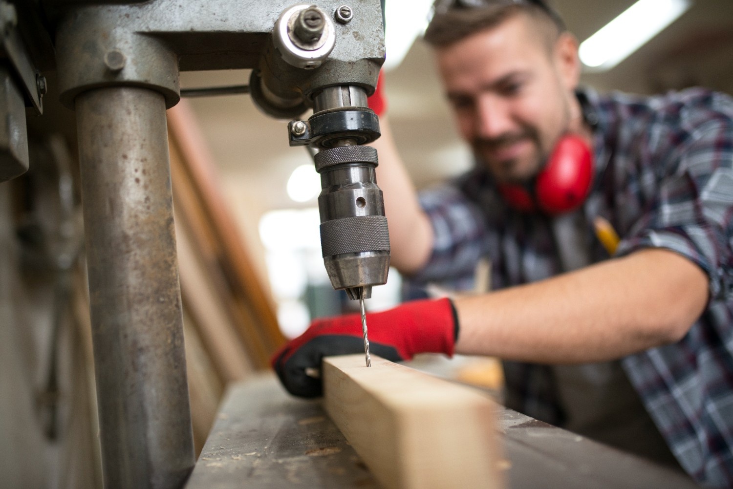 hardworking-professional-carpenter-drilling-wood-material-with-vertical-drill-machine